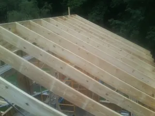 New roof rafters set over an addition before sheathing in Endicott