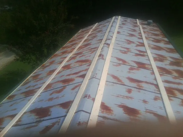 Rusted metal roof panels with new wood purlins before replacement — Storm Damage Roof Repair in Endicott by Roofing Brothers